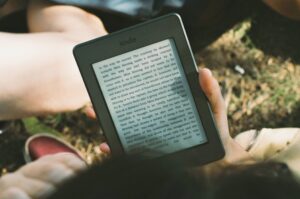 a hand holding an e-reader